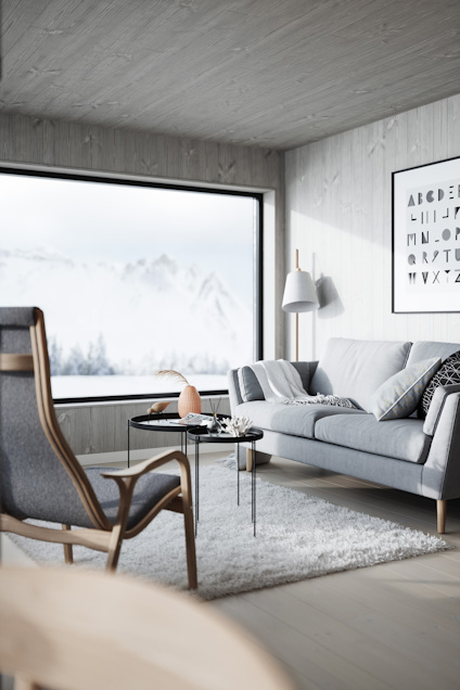 Modernt vardagsrum med stor fönsterutsikt över snötäckta berg, grå soffa, fåtölj, glasbord och lampa. Abstrakt konst på väggen.