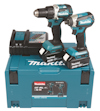 Två Makita sladdlösa borrmaskiner med batteripaket ovanpå en blå verktygslåda med texten "Makita".