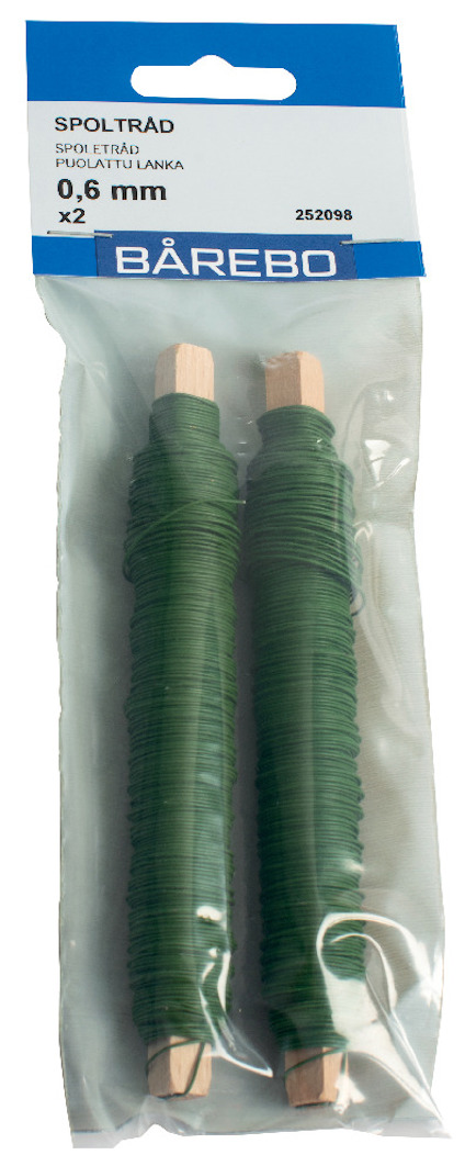 Två gröna spoltrådar med etikett "SPOLTRAD 0,6 mm" i plastförpackning från märket Bårebo.