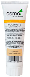 Vit tub märkt "osmo Holzpaste" med text och streckkod. Indikerar träspackel för furu.