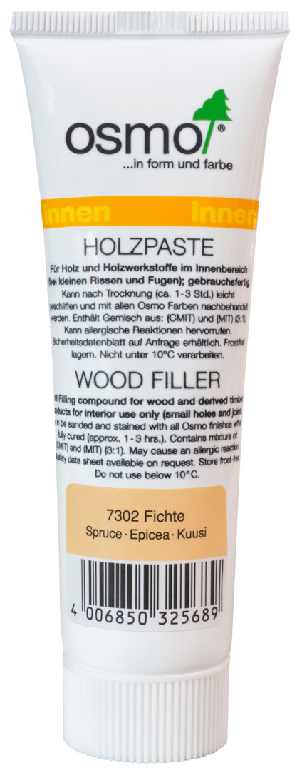 Vit tub märkt "osmo Holzpaste" med text och streckkod. Indikerar träspackel för furu.